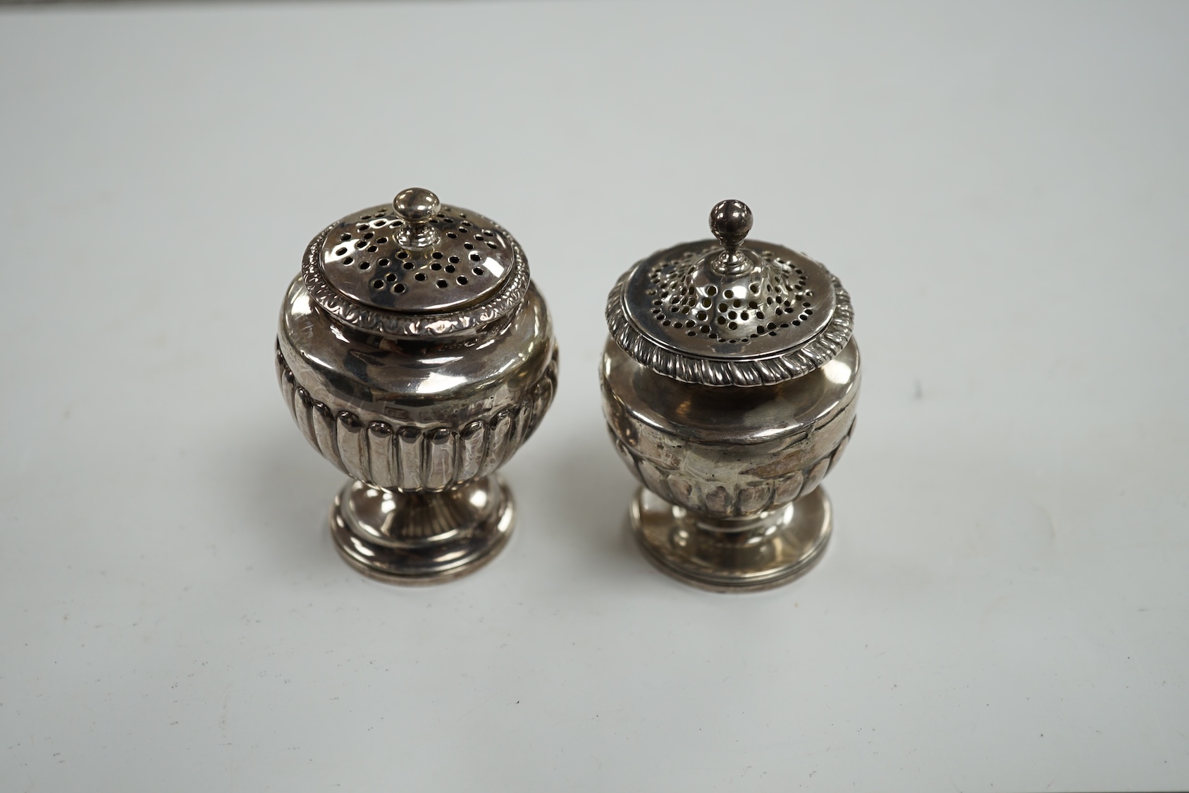 A George III silver pedestal pepper pot, by Eames & Barnard, London, 1816, 75mm and one other similar pepper pot, marks rubbed. Condition - poor